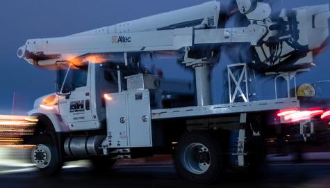 Black Hills Energy service truck driving with motion-blurred lights 